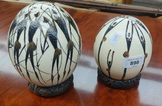 Two south African ostrich eggs with hand painted decorative design