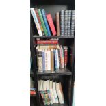 Three shelves of various mixed books