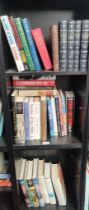 Three shelves of various mixed books