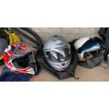 Three various Bike helmets and carry bags.