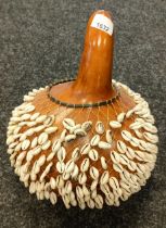 An African Shekere Gourd Rattle with small cowrie type shells to the net covering