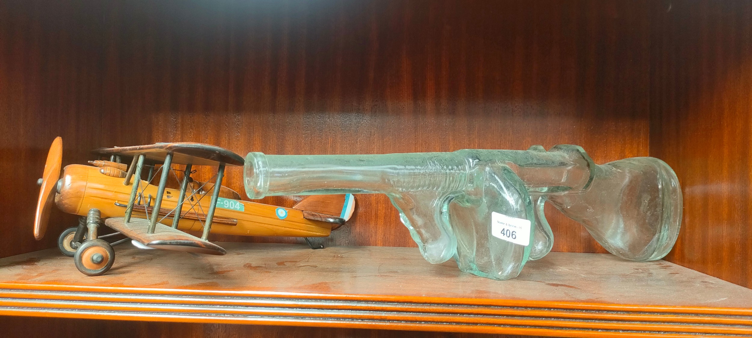 Vintage pressed glass tommy gun decanter and wooden plane model