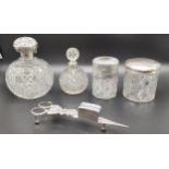 Four silver and cut crystal perfume bottles and preserve pots; Silver tops and collars. Together