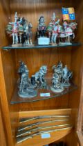 Three shelves of collectable lead and pewter figurines.
