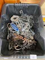 Box containing a large quantity of mixed vintage car badges; Ford, Civic, Nissan, Renault and Suzuki