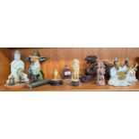 A shelf of oriental collectable figures