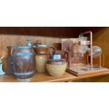 A shelf of collectables to include Doulton Lambeth ware jugs and a copper distillery model