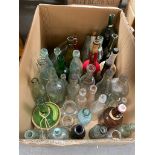 Box containing a quantity of antique and vintage glass bottles.