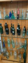 Four shelves of collectors glass bottles; Large Poison bottle, Gilbert Rae of Dunfermline soda