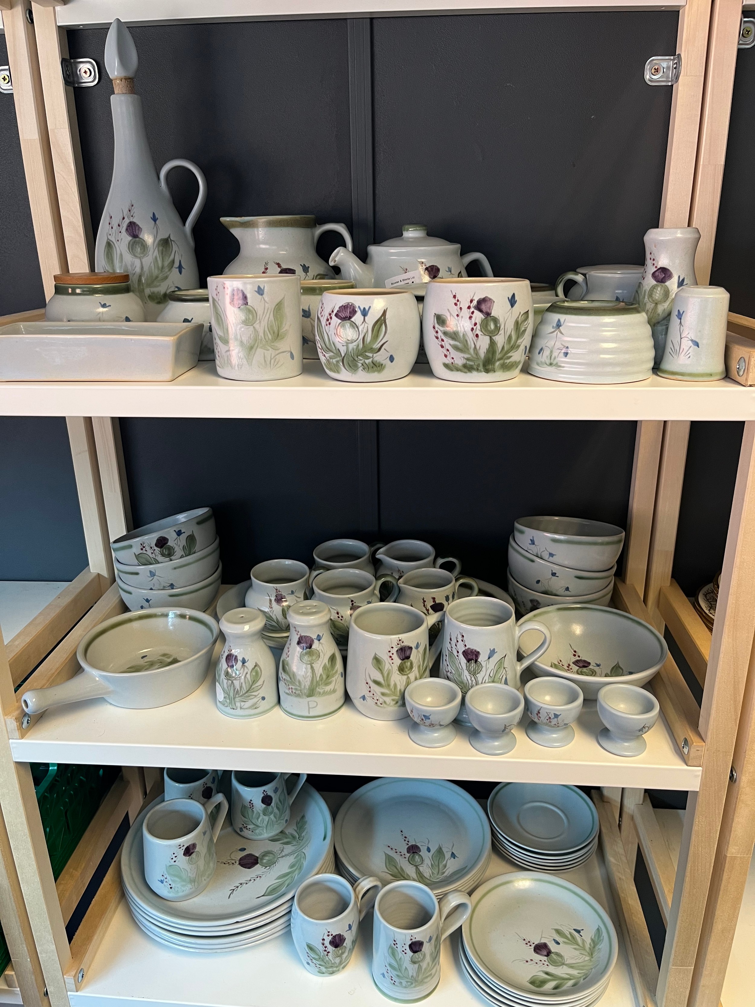 Three shelves of Buchan Pottery; Dinner service, tea cups and saucers, preserve pots and many more