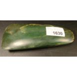 A polished green hardstone axe head