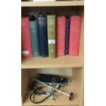 Shelf of medical books along with medical instruments