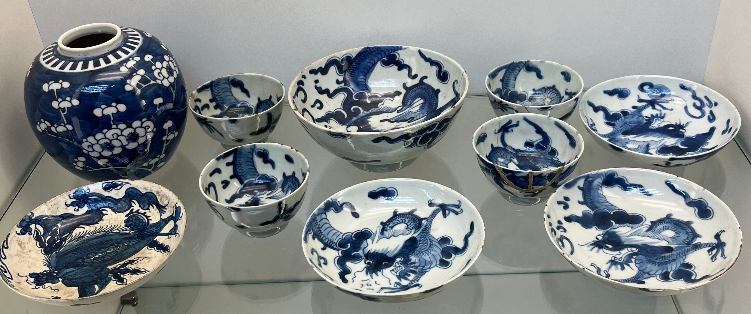 Selection of Antique Chinese blue and white dragon design cups and saucers, matching bowl, one other