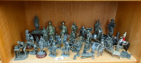 A shelf filled with silver plated/ pewter figurines of differing genres, London Buskers by J Pitts