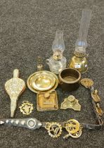 Selection of antique brass wares; Brass and glass paraffin lamp, Waterloo Napoleon figural bell,