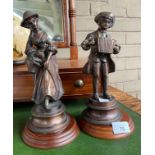 A Pair of Bronze him and her sculptures. Sat upon wooden bases