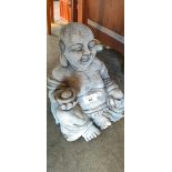 Garden concrete sitting laughing buddha figure.