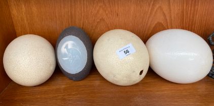 Four various ostrich eggs; Australian Aboriginal art ostrich egg detailing a carved wallaby