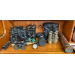 A large collection of binoculars to include Strand London and brass telescopes