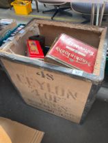 Tea crate containing a collection of mixed advertising tins.