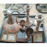 Tray of collectables; Claret jug, Pair of candlesticks, Silver foreign raised relief pictures,