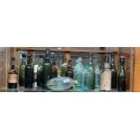 A shelf of collectable bottles to include names such as; [Robert Barr] [J.J Miller] [MacLay & Co