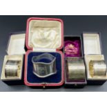 Four various boxed Silver napkin rings; Pair of silver machine worked napkin rings, Victorian
