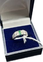 18ct white gold ring set with white sapphires and green stones. [Ring size L] [5.22Grams]