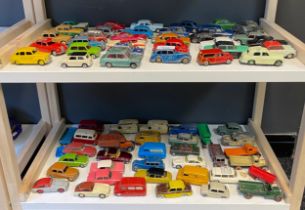 Two shelves of playworn car models, mostly Corgi and Dinky