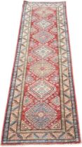 A Large Persian style hall runner rug. [262x84cm]