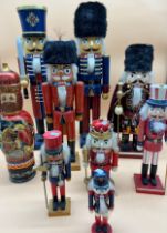 A Collection of eight Varying sized nutcrackers and large Russian doll type figure. [Tallest- 62cm