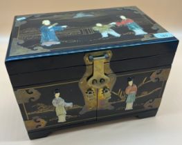 Chinese lacquered and brass bound jewellery box. Raised relief carved stone figures to the top