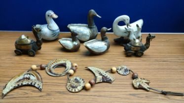 A Selection of collectables; Carved wood and pottery duck sculptures, two wooden carved camel toys