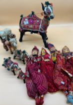 A Selection of Indian collectables; Four various puppets and material made camels.