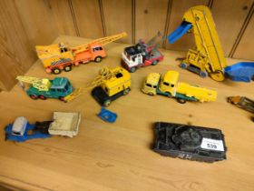 A box of play worn vehicles includes dinky military vehicles and others