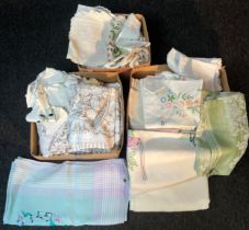 Three boxes of mixed vintage table covers and dollies. Hand stitched items included.