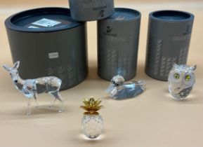 Four various Swarovski crystal sculptures; Doe deer, Duck, Owl and Pineapple. All with boxes. [Deer-