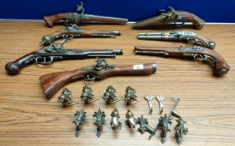 A Collection of reproduction flint lock pistol display guns. Comes with wall fittings. Seven in