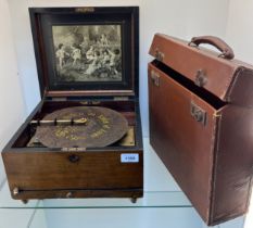 A Victorian Polyphon metal disc player. Fitted within a Walnut box. In a working condition and comes
