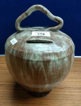 Antique drip glaze pottery bank with handle. [23cm high]