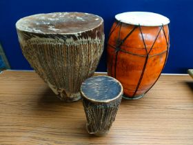 Three various hand drums; two made from animal hide. [46cm high- tallest]