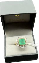18ct yellow gold ring set with a large cut Emerald stone surrounded by 0.60cts of diamonds. [