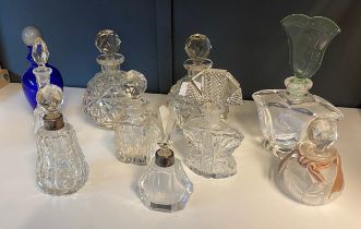 A selection of various 1900s perfume bottles includes silver marked collars