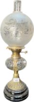 Antique cut glass and brass base paraffin lamp, funnel and glass dome present. [57cm high]