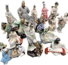 A Large selection of Oriental figurines; Mud men sculptures and geisha sculptures. [Tallest- 33cm]