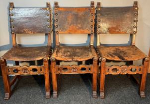 Seven 19th century Jacobean style Walnut and leather chairs; Leather and stud trim finish. Carved