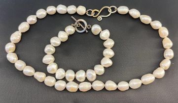 A baroque pearl necklace with a 9ct white gold clasp and catch, Similar necklace with silver clasp