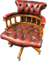 Chesterfield captains chair, covered in an oxblood leather with button detail throughout [80x62.