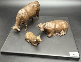 Angela Hunter Bronzed pottery sculpture of three cows sat upon a slate base. [Base- 35cm square] [