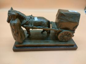 J.H. Clark Bronze Sculpture of a Women with a horse and cart. Signed. Sat on a wooden block.